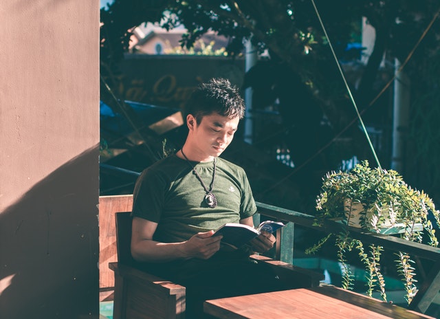 A man reading on the balcony