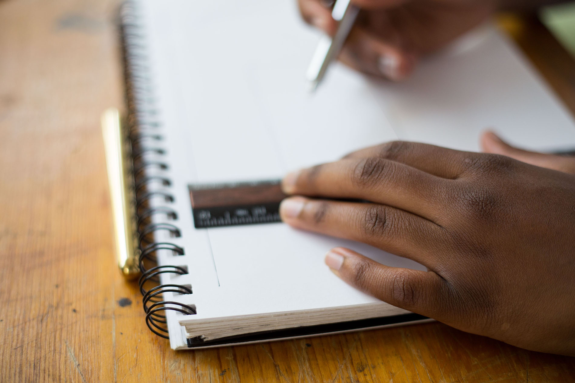 person making a notes in notebook