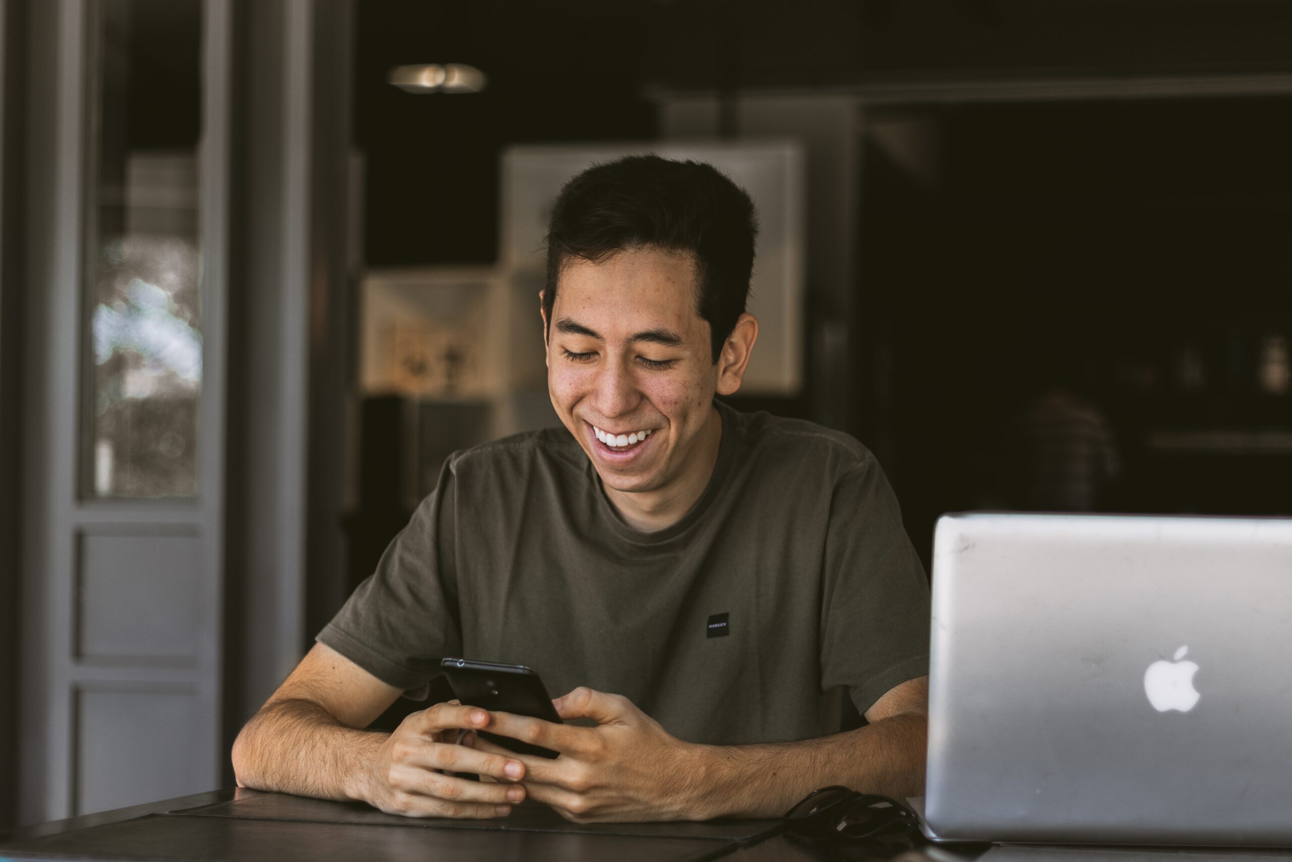 man looking at his phone and smiling